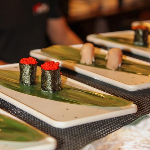 Kanpai Sushi's gunkan maki with red roe and nigiri on banana leaves, ready to be served.