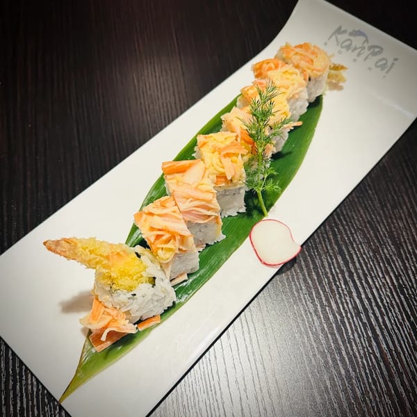 Kanpai Sushi's sushi roll with tempura shrimp, crab, and dill on a banana leaf.